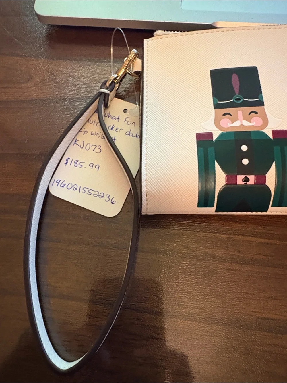 kate spade beige wristlet with colorful nutcracker trio